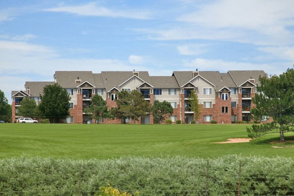 Westlake Greens brick apartment buildings with green grass and trees in front