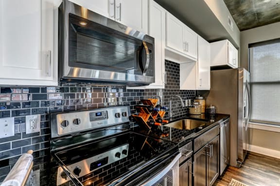Kitchen with black appliances,cabinets and Fridge at Aertson Midtown, Nashville, TN