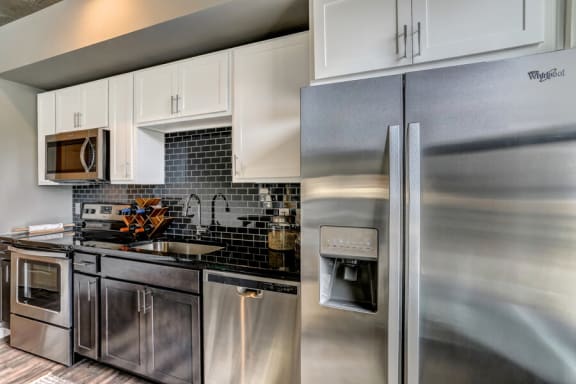Kitchen with black appliances and cabinnets at Aertson Midtown, Nashville, TN, 37203