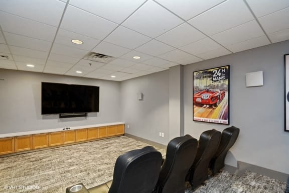 a small conference room with a flat screen tv and leather chairs at 3333 Wisconsin, Washington, Washington