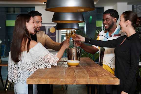 a group of people toasting at a table