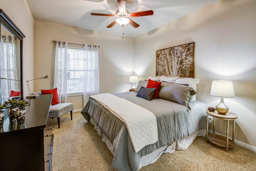 Abelia Flats bedroom with carpet, ceiling fan, and natural light - Austin, TX