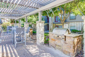 North Austin Apartments - Shaded Gas BBQ Grills With High-Chairs And Tables. BBQ Area Is Located Near Apartment Homes.
