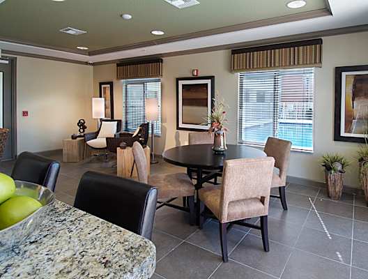 a dining room and living room with a table and chairs