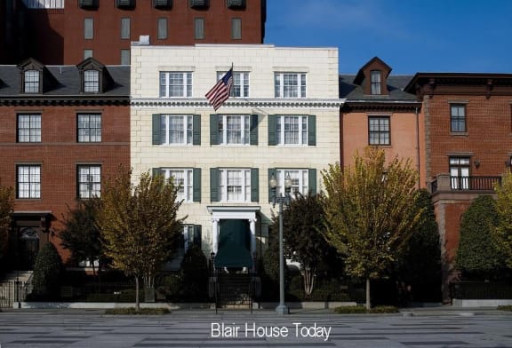 a white building with an american flag in front of it