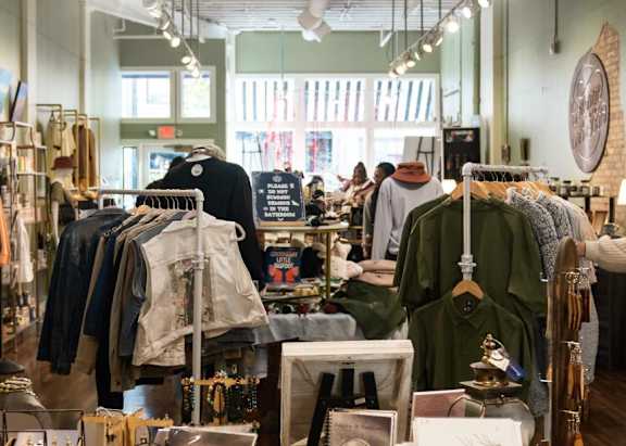 Clothing racks in a local boutique near Off Broadway Apartments in Grand Rapids