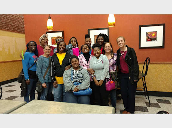 A group of people are posing for a picture in a restaurant.