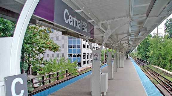 A train station platform with a sign that says Central Loop to Howard.