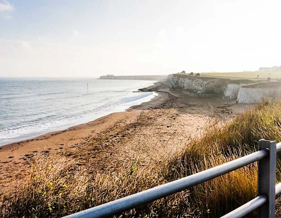 a sandy beach next to a body of water at UnionView Apartments, Dartford DA2 6GZ