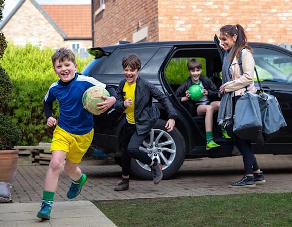 a group of children running out of a car at UnionView Apartments, Dartford DA2 6GZ