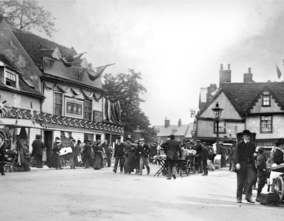 a crowd of people walking down a city street