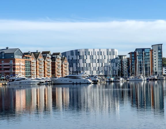 a city by the water with boats and buildings