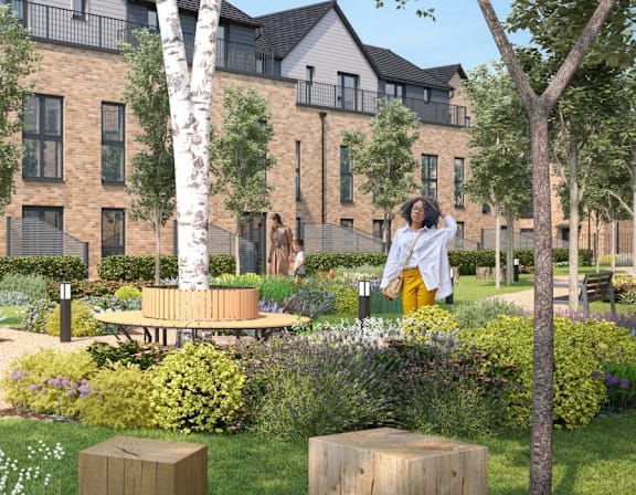 a woman standing in a garden in front of a building