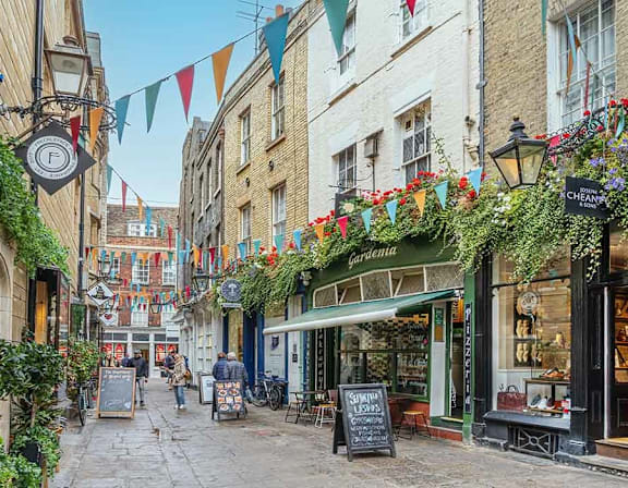 A street scene with a flower shop named Chevalier at Origins Apartments, Cambridge