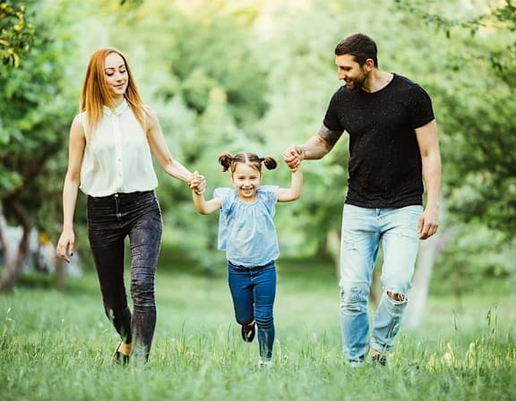 a family walking through the grass with a little girl at UnionView Apartments, Dartford, KENT DA2 6GZ