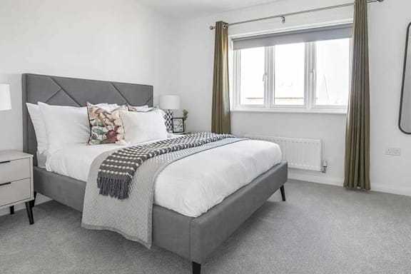 a bedroom with a bed and a window at UnionView Apartments, Dartford, KENT