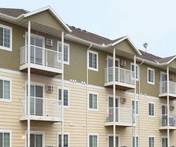 The gray and tan apartment building at Roosevelt East Apartment Homes. 