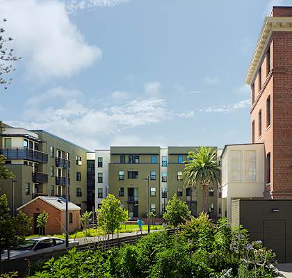 a rendering of an apartment building on a city street