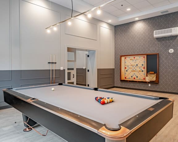 social room with a pool table and life size scrabble board