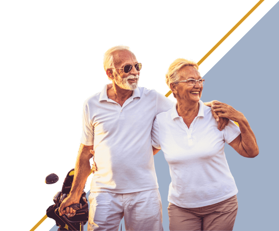 An elderly couple is walking together, holding hands.