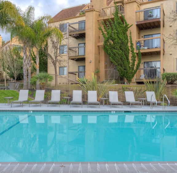 Pool with lounge chairs at BELLA VISTA AT HILLTOP, Richmond, 94806