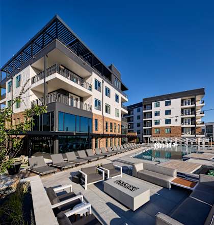 A modern building with a pool in front.