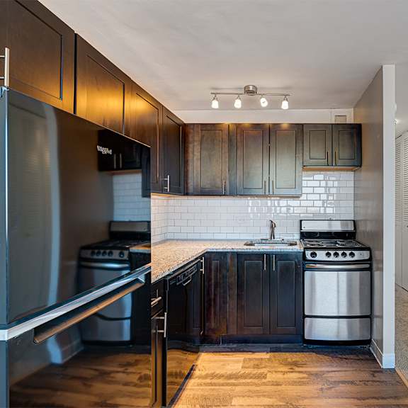 a kitchen with stainless steel appliances and wooden cabinets