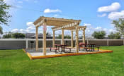 Thumbnail 2 of 20 - BBQ grills with picnic tables under a gazebo