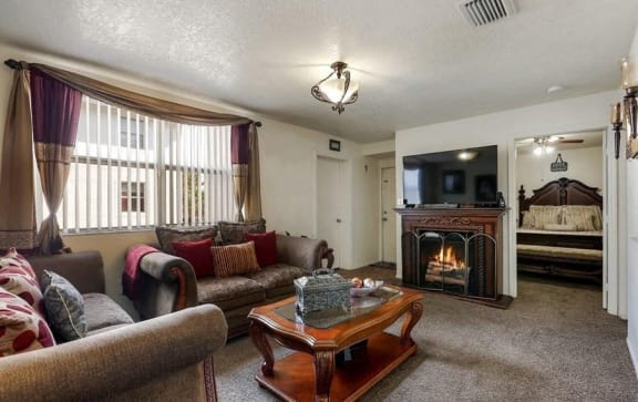 Model living room with couch and fireplace