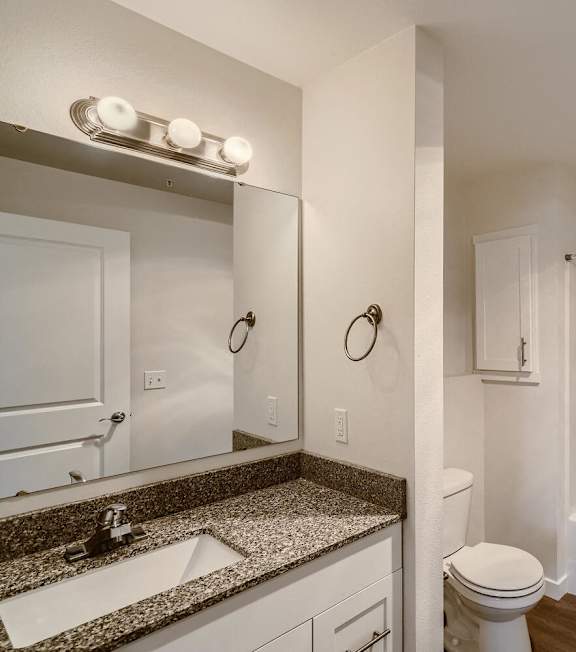 A white bathroom with a sink, toilet, and bathtub.