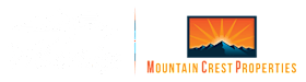 A mountain silhouette is set against a bright sunrise or sunset.
