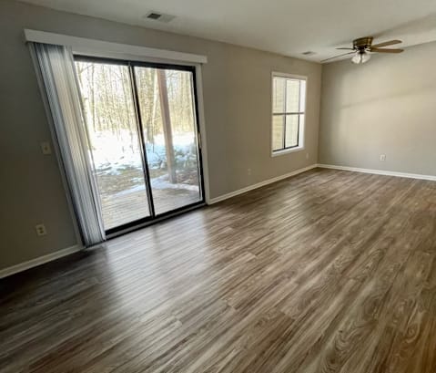 an empty living room with a sliding glass door