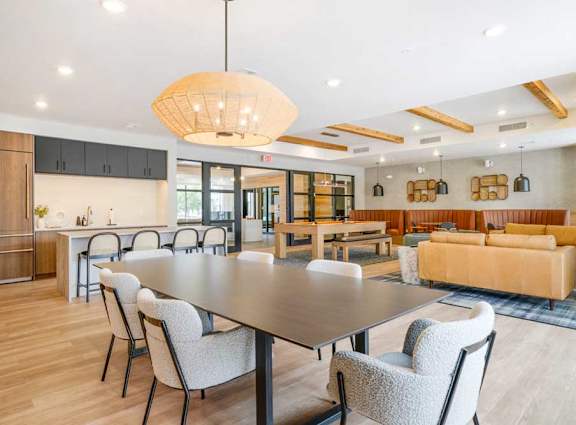 A modern dining room with a large table and chairs.
