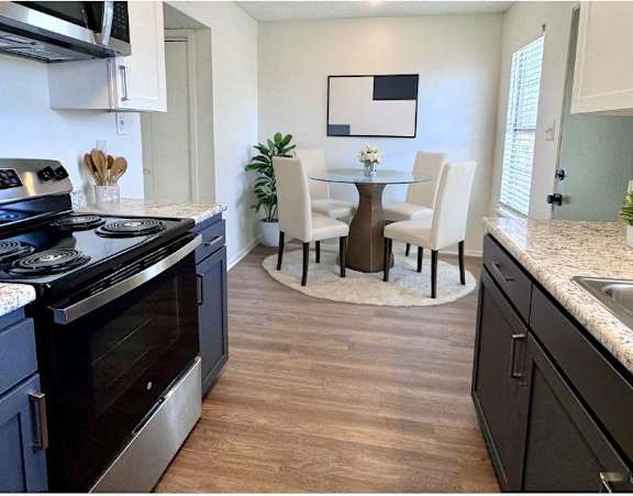 a kitchen and dining room with a table and chairs