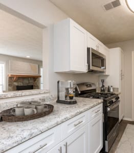 a kitchen with white cabinets and granite counter tops at Edgemont Apartments, PRG Real Estate, Greenville, 29615
