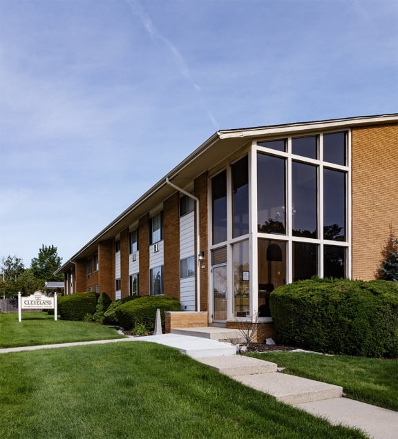 the front of a brick building with large windows