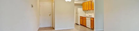 View of living area, kitchen, and entrance at Broadfalls in Falls Church, VA