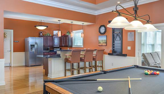 A room with a pool table and a framed picture on the wall.