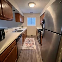 a kitchen with wooden cabinets and stainless steel appliances