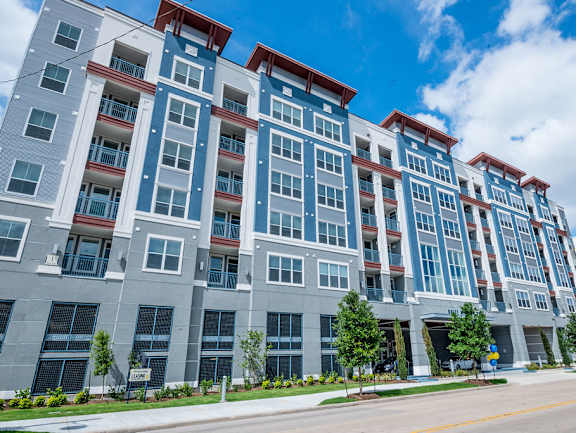an apartment building with a street in front of it