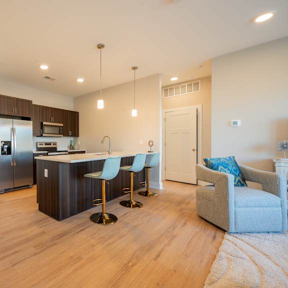 A modern kitchen with a dining table and chairs.