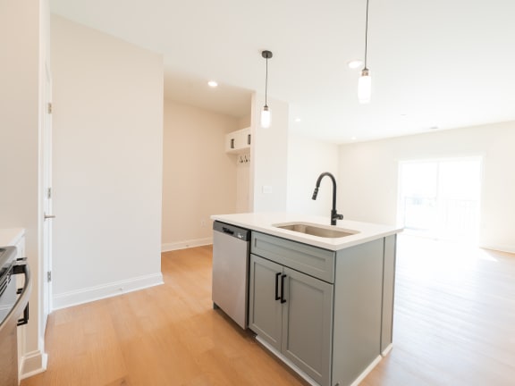 a renovated kitchen with a large island in the middle