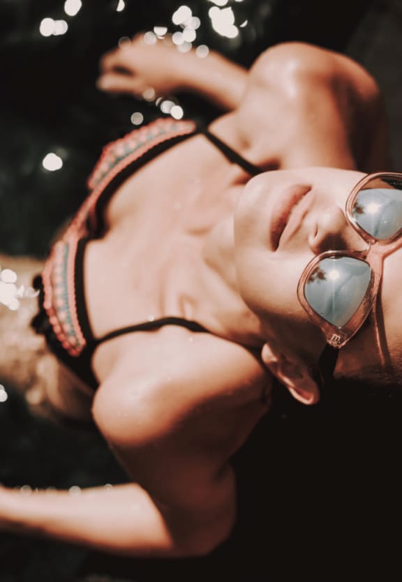 Woman Wearing Sunglasses Relaxing in Pool
