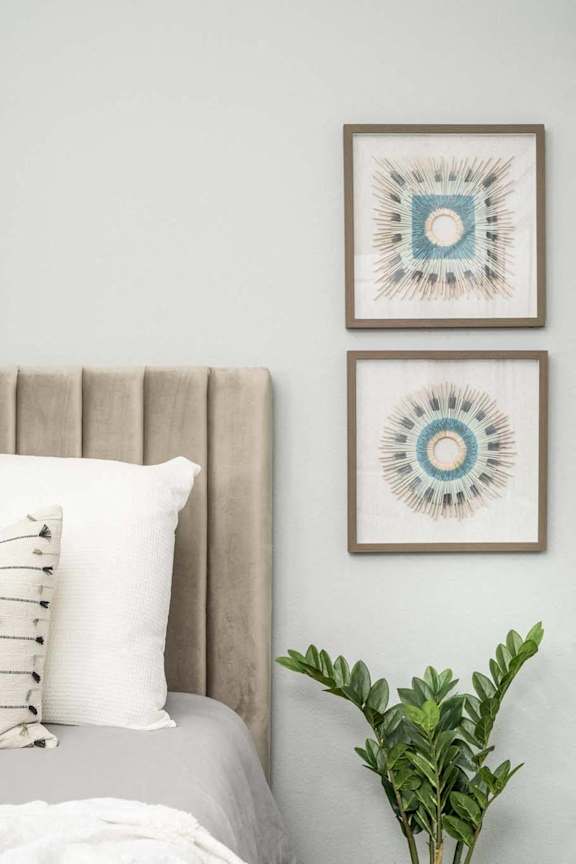 a bedroom with a bed and two paintings on the wall at Grandstone at Sunrise, Peoria, AZ, 85383