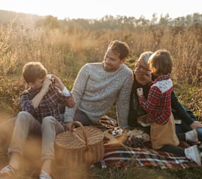 A family enjoying a picnic in a field.