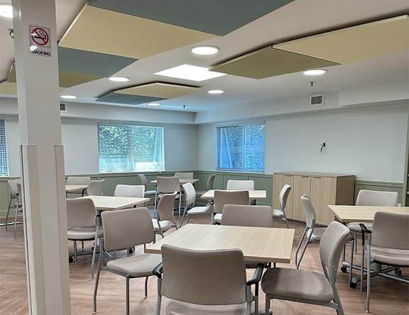 A room with tables and chairs and a no smoking sign.