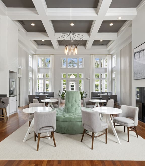 a living room with a green couch and tables and chairs at Breakers Point, South Carolina, 29579
