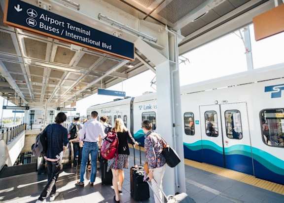 A train station with people waiting to board a train.