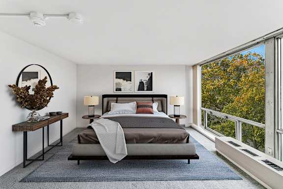 a bedroom with a bed and a large window
