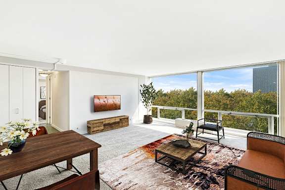 a living room with a large window and a view of the city